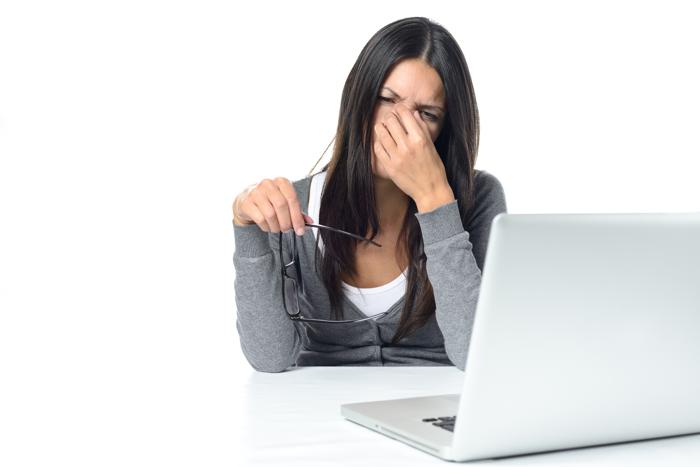 Woman suffering from eye strain at her laptop